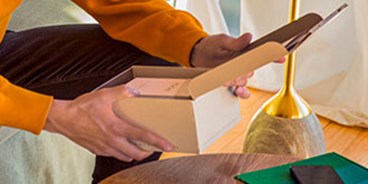 a man unboxing an iqos original duo